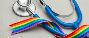 Sex reassignment surgery image with stethoscope and LGBT rainbow ribbon.