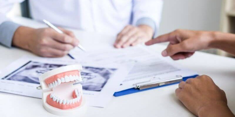 Dentist discusses tooth decay with patient